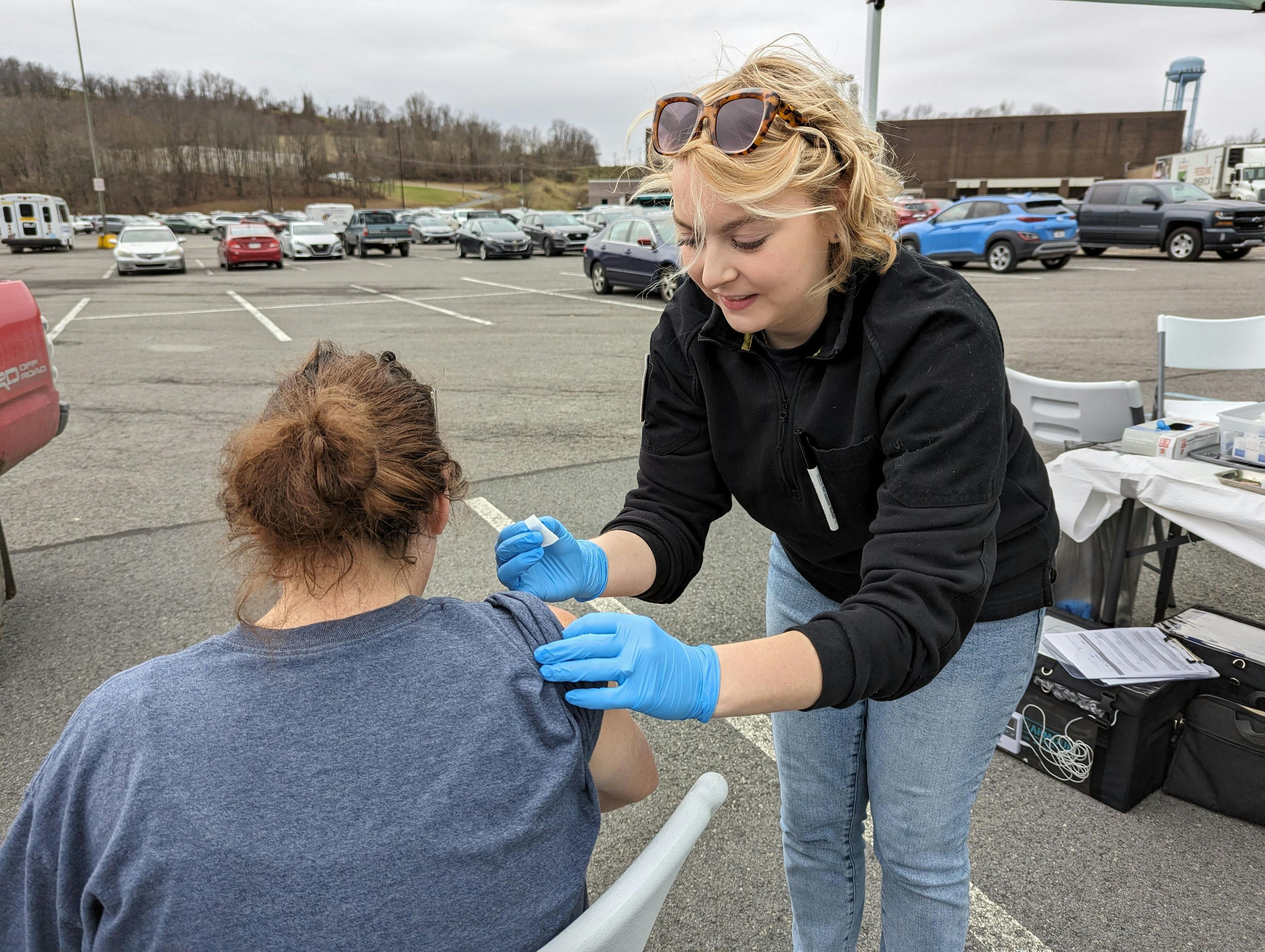 Brittany Irick talks to a TV reporter at a Free Naloxone Day in 2023